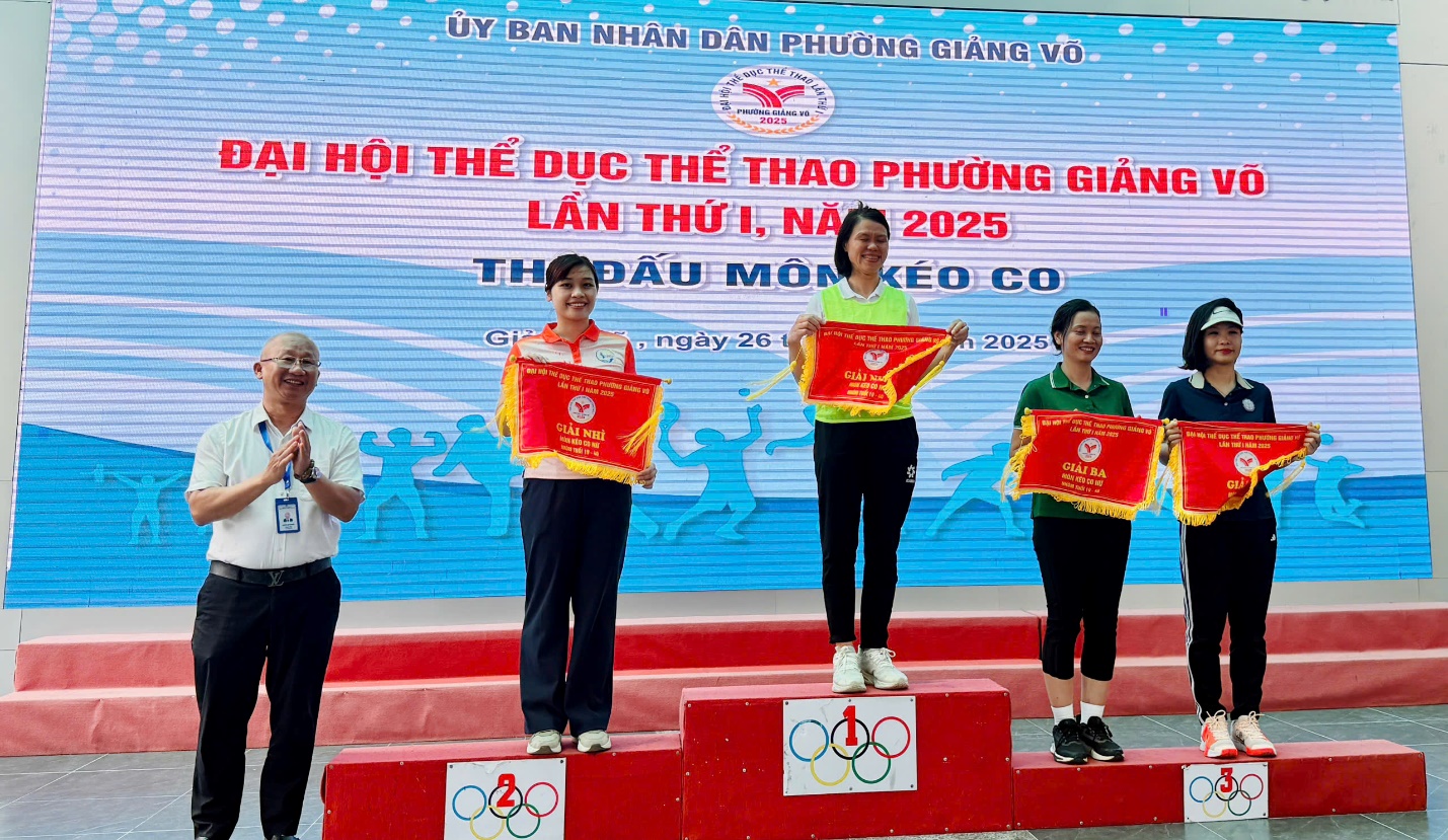 A group of people standing on a podium holding flags
AI-generated content may be incorrect.