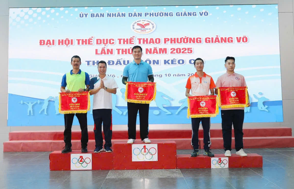 A group of men standing on a podium with flags
AI-generated content may be incorrect.