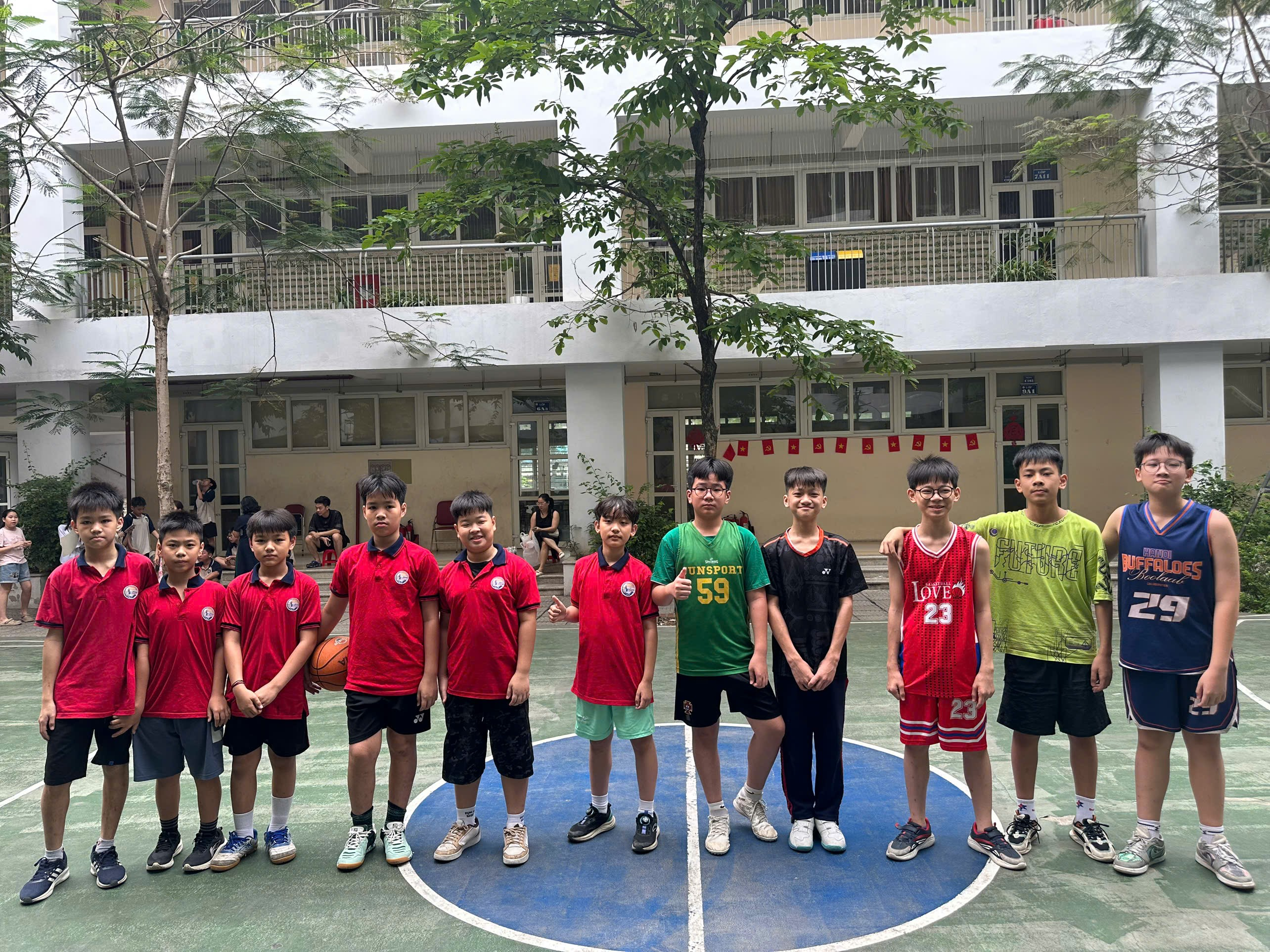 A group of boys standing on a basketball courtAI-generated content may be incorrect.