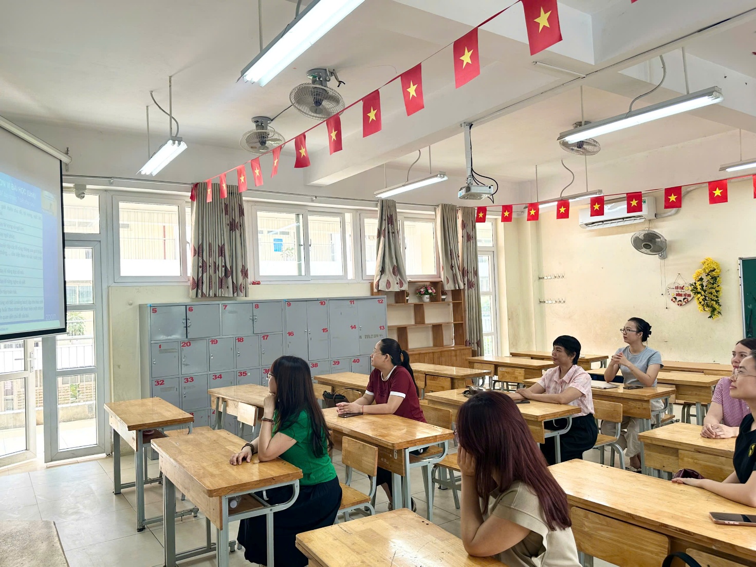 A group of people sitting at desks in a classroom