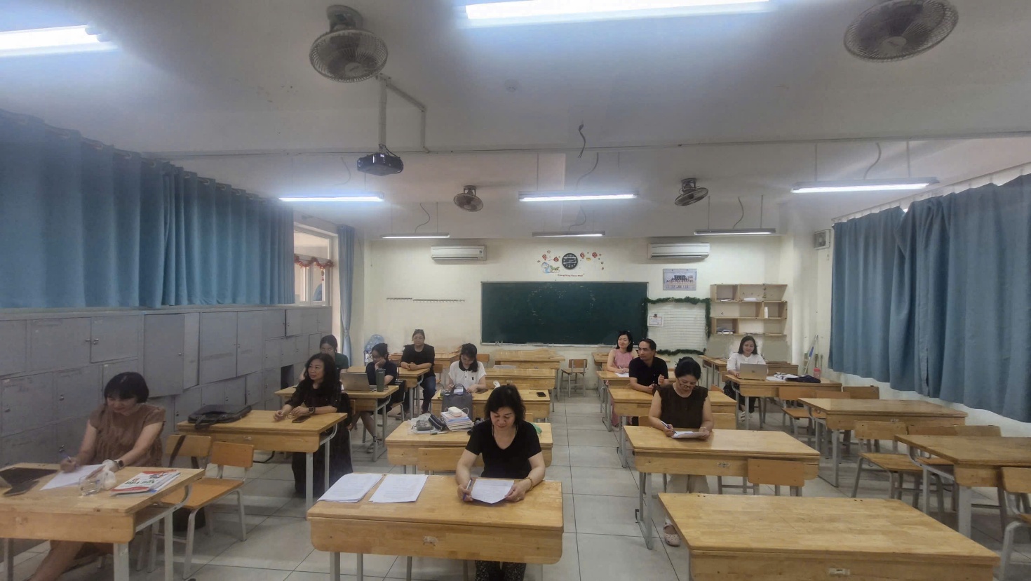 A group of people sitting at desks in a classroom