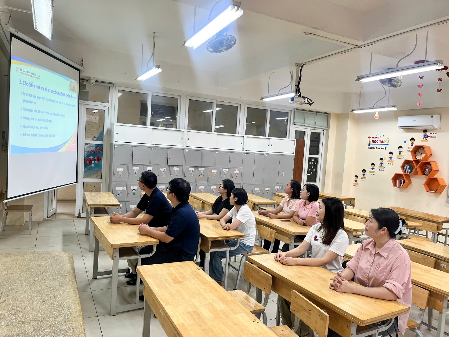 A group of people sitting at desks in a classroom

AI-generated content may be incorrect.