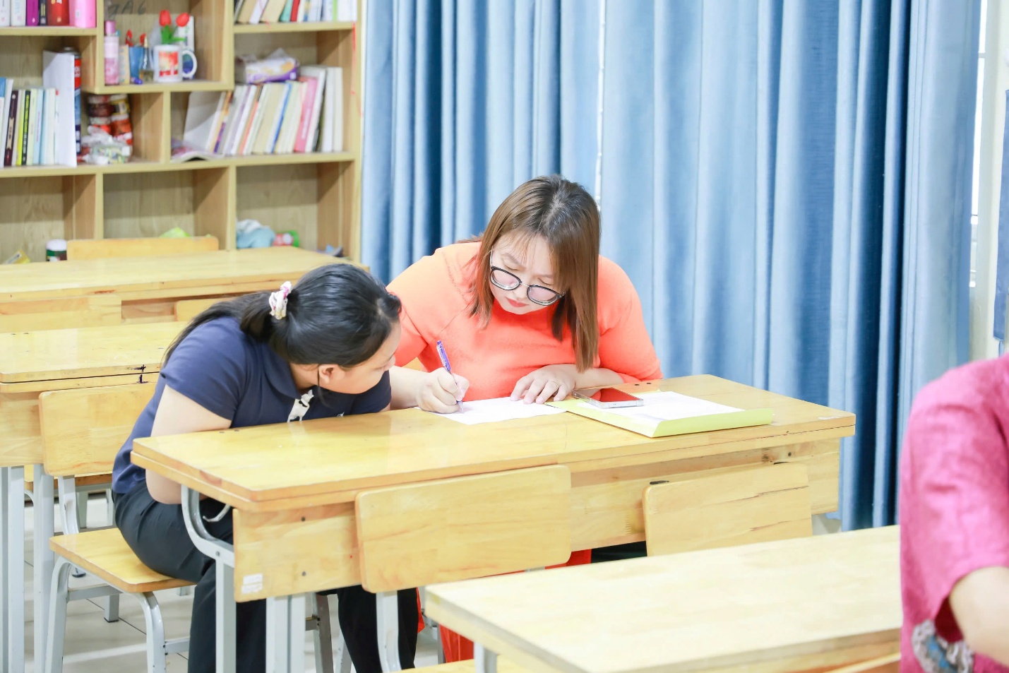 A person writing on a bookAI-generated content may be incorrect.