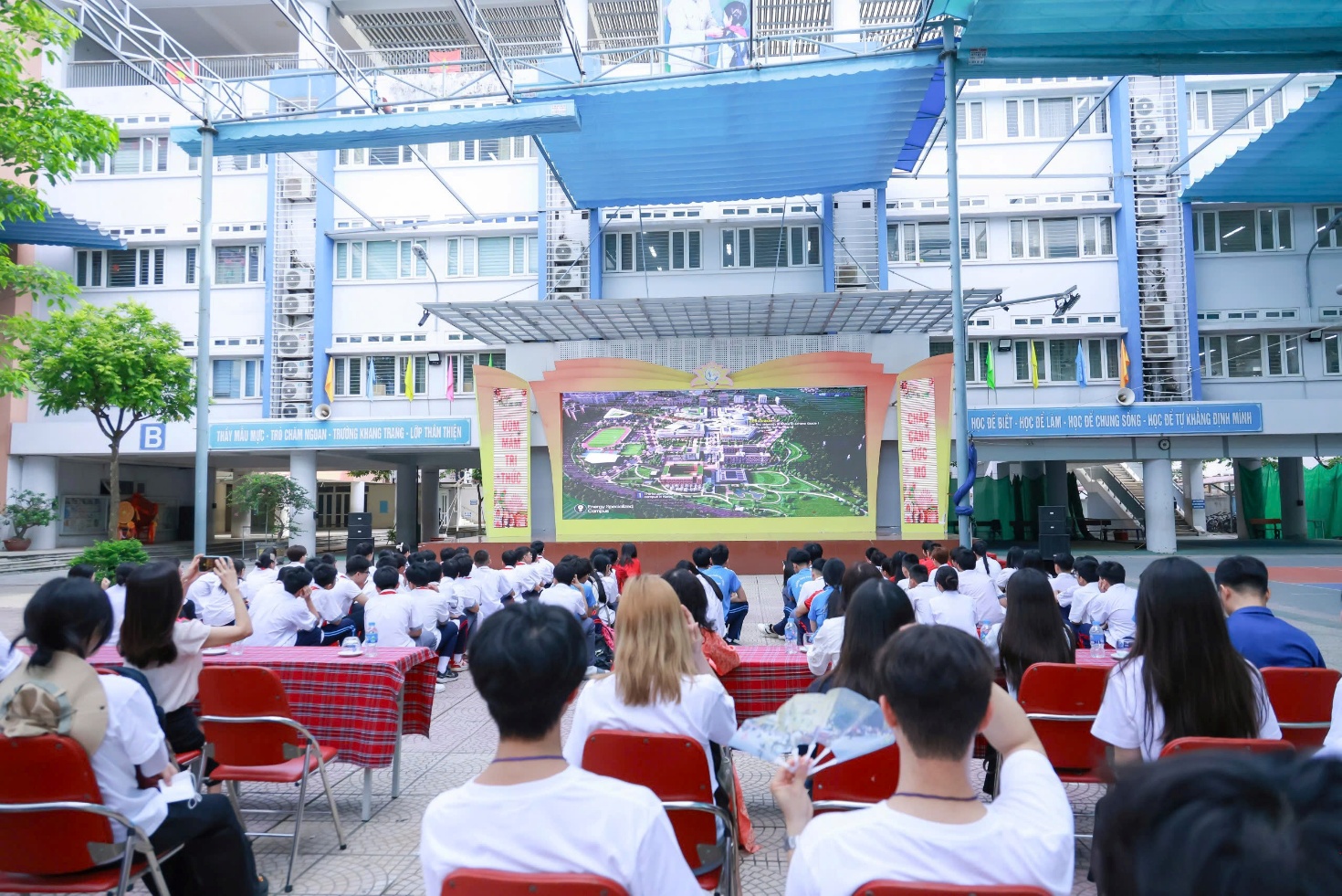 A group of people sitting in chairs in front of a screen

AI-generated content may be incorrect.
