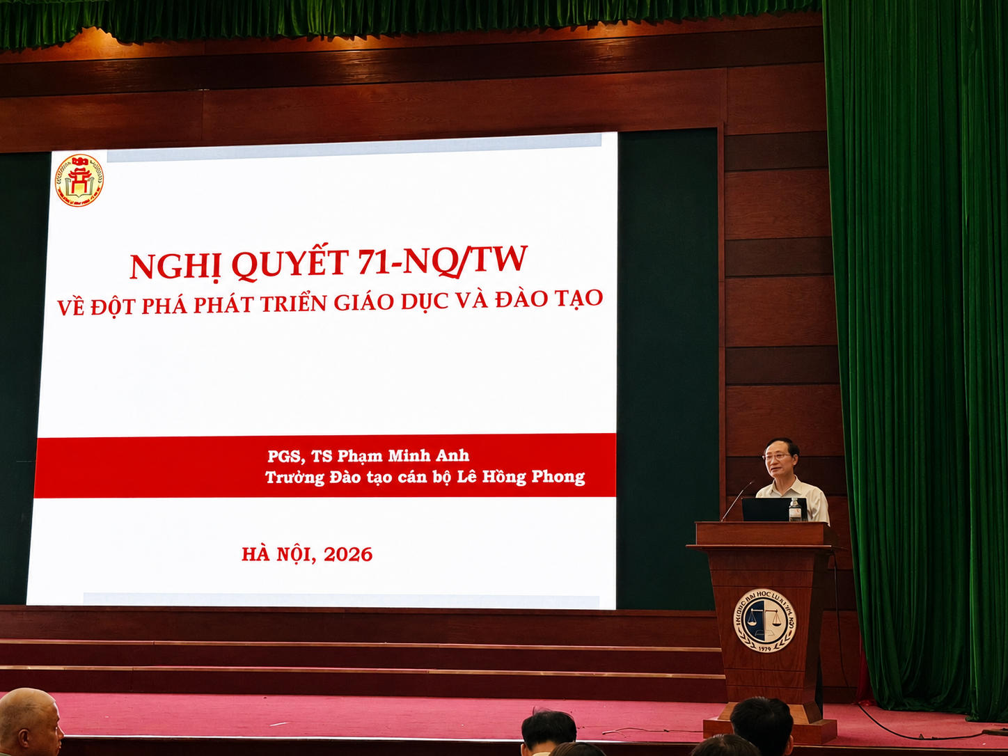 A person standing at a podium with a screen on itAI-generated content may be incorrect.