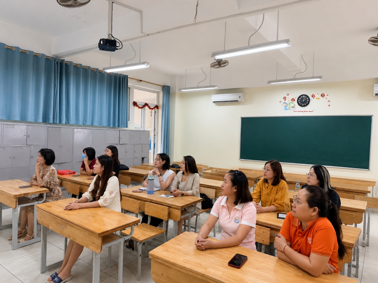A group of people sitting at desks in a classroomAI-generated content may be incorrect.