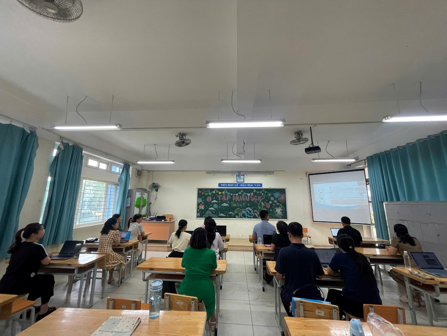 A group of people sitting at desks in a classroom

AI-generated content may be incorrect.